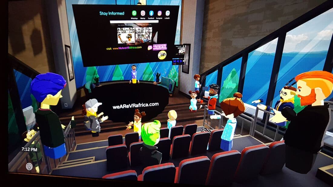 AltspaceVR auditorium with avatars in red seats and on the stage stairs